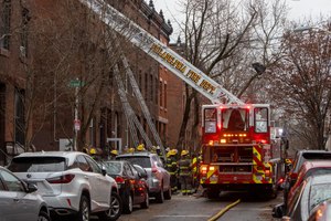 Philadelphia fire department members worked at the scene of a deadly fire at a three-story rowhouse in the city's Fairmount neighborhood on Wednesday.