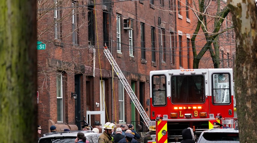 Philadelphia firefighters work at the scene of a deadly row house fire, Wednesday, Jan. 5, 2022, in the Fairmount neighborhood of Philadelphia.