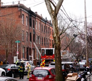 Philadelphia firefighters work at the scene of a deadly row house fire, Wednesday, Jan. 5, 2022, in the Fairmount neighborhood of Philadelphia. Officials say firefighters and police responded to the fire at a three-story rowhouse early Wednesday around 6:40 a.m. and found flames coming from the second-floor windows.