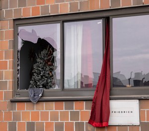 A curtain hangs outside a window at an apartment building in the Bronx on Sunday, Jan. 9, 2022, in New York, where a fatal fire occurred, in what the city's fire commissioner called one of the worst blazes in recent memory.
