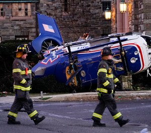 A medical helicopter rests next to the Drexel Hill United Methodist Church after it crashed in the Drexel Hill section of Upper Darby, Pa., on Tuesday, Jan. 11, 2022.