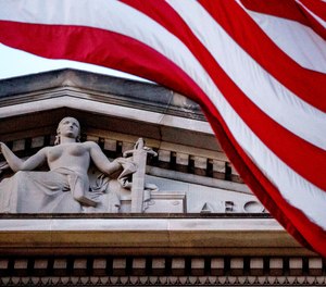 An American flag flies outside the Department of Justice in Washington, March 22, 2019.