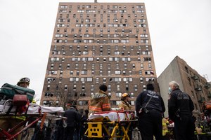 FDNY firefighters and paramedics worked at the scene of a fatal fire at an apartment building in the Bronx on Sunday.