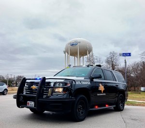 A Texas state trooper blocks traffic on a road leading to a Colleyville, Texas, synagogue where a man apparently took hostages, Saturday, Jan. 15, 2022. (