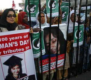 People rally demanding the release of Aafia Siddiqui during International Women's Day in Karachi, Pakistan, Tuesday, March 8, 2011.