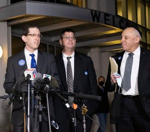 Charlie Cytron-Walker, rabbi of Congregation Beth Israel, center, makes a statement to the media after a service at White's Chapel United Methodist Church in Southlake, Texas, Monday, Jan. 17, 2022.