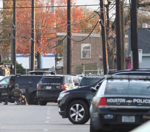 Houston Police officers work at a scene Thursday, Jan. 27, 2022, where a shootout that wounded three officers.