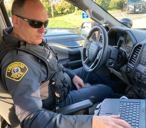 Lynnwood police Officer Denis Molloy works in his vehicle, Wednesday, Nov. 17, 2021, in Lynnwood, Wash.
