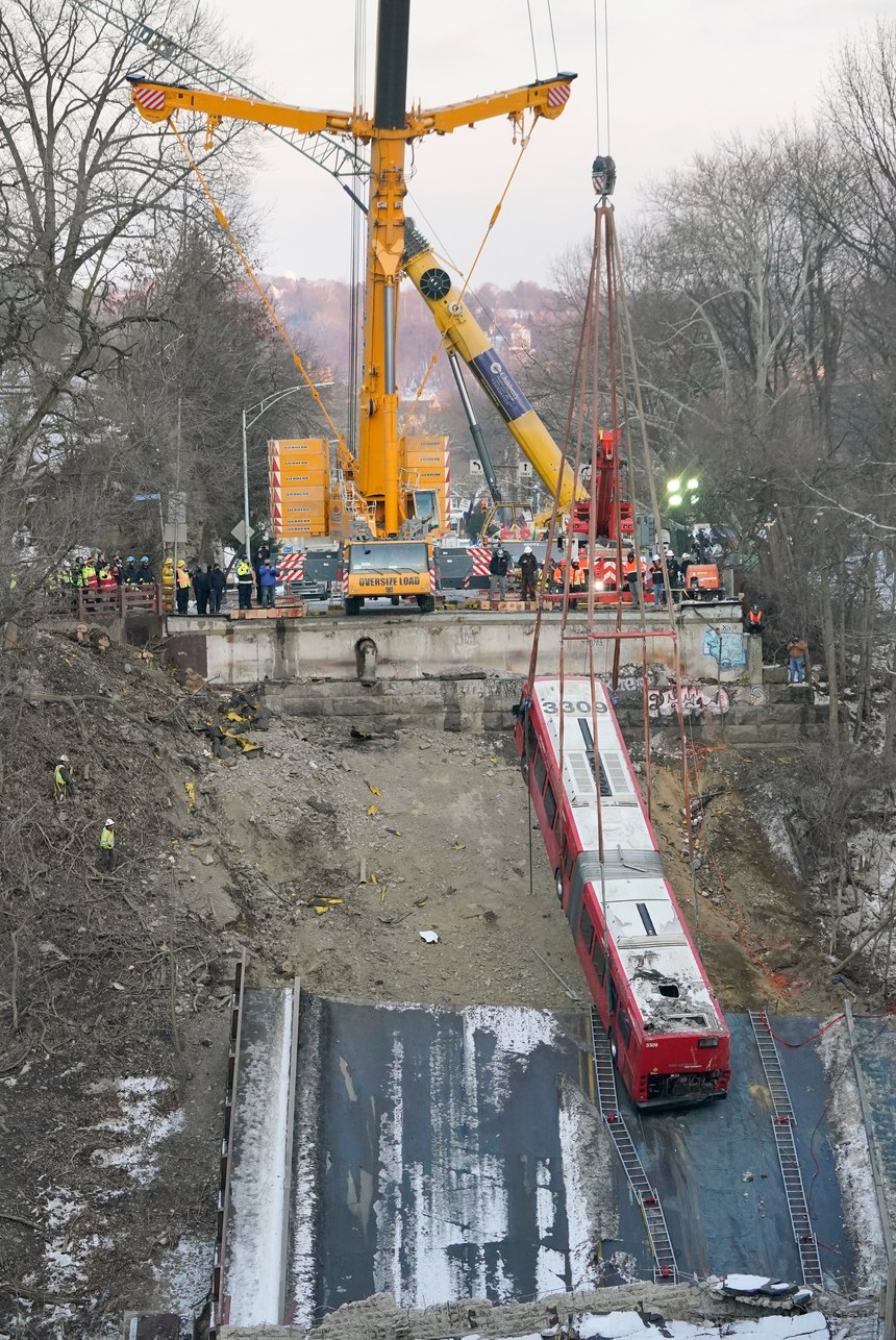A crane lifted the crashed bus on Monday. 