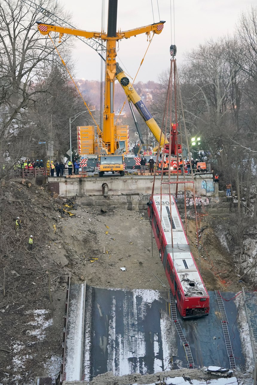 A crane lifted the crashed bus on Monday.