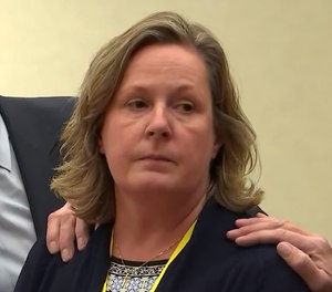 In this screen grab from video, former Brooklyn Center Police Officer Kim Potter stands with defense attorney Earl Gray, as the verdict is read Dec.,23, 2021 at the Hennepin County Courthouse in Minneapolis.