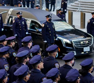 A hearse carrying the casket of New York City Police Officer Wilbert Mora is delivered to St. Patrick's Cathedral for his wake, Tuesday, Feb. 1, 2022, in New York.