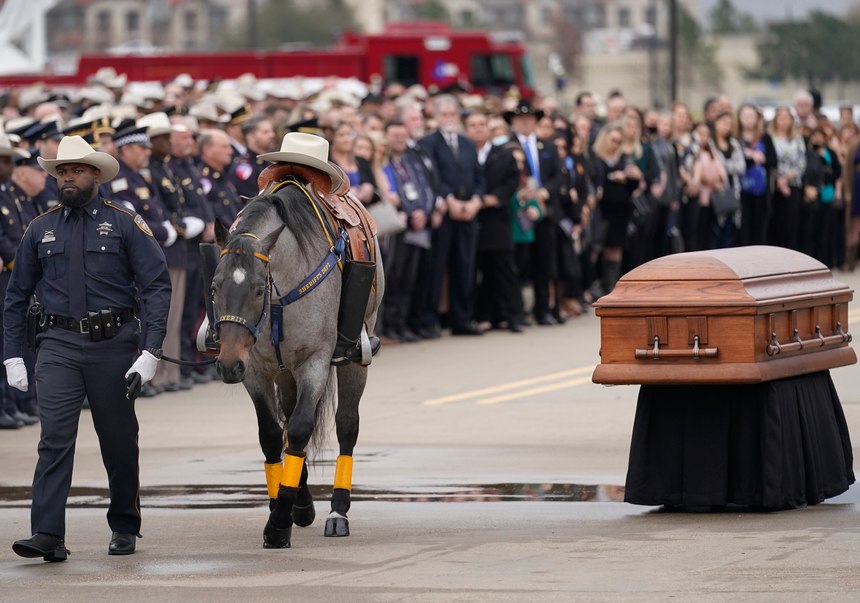 A member of the Harris County Sheriff's Office Mounted Patrol leads a riderless horse during the funeral service for Harris County Constable Precinct 5 Cpl. Charles Galloway at the Second Baptist Church West Campus in Houston on Tuesday, Feb. 1, 2022.