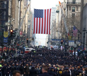 New York Police officers begin to arrive along Fifth Avenue outside St. Patrick's Cathedral for Officer Wilbert Mora's funeral, Wednesday, Feb. 2, 2022, in New York.