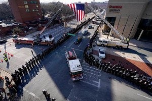 A fire engine carrying the casket of Lt. Kelsey Sadler is seen during a procession following a funeral for her and two other firefighters on Feb. 2 in Baltimore. A fourth firefighter was injured and transported to a hospital.