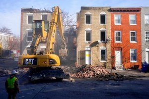 An excavator was at the site of a fatal fire at a vacant rowhouse on Jan. 24 in Baltimore.