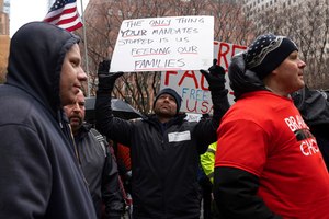A person holds a sign during an anti-vaccine mandate protest Monday in New York.