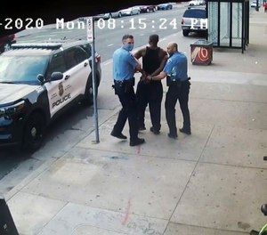 Security video shows Minneapolis police Officers Thomas Lane (left) and J. Alexander Kueng escorting George Floyd to a police vehicle in Minneapolis, on May 25, 2020.