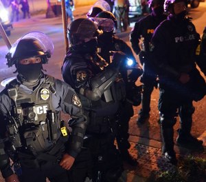 Police speak with protesters at the First Unitarian church, in Louisville, Ky., Sept. 24, 2020.