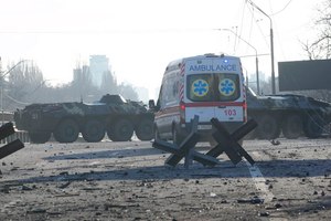 An ambulance was parked near a barricade and Ukrainian armored vehicles in a street in Kyiv on Saturday.