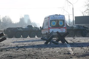 An ambulance was parked near a barricade and Ukrainian armored vehicles in a street in Kyiv on Saturday.