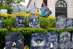 Jayde Newton helped set up cardboard gravestones with the names of victims of opioid abuse outside the courthouse where the Purdue Pharma bankruptcy trial was taking place in White Plains, N.Y., on Aug. 9, 2021.
