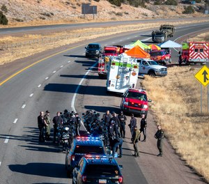 Law enforcement gathers along Interstate 25 as several agencies take part in a search for a suspect who was involved in a high speed pursuit that resulted in a Santa Fe Police Officer being killed, Wednesday March 2, 2022.