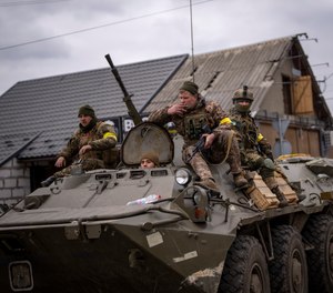 Ukrainian soldiers drive on an armored military vehicle in the outskirts of Kyiv, Ukraine, Saturday, March 5, 2022.