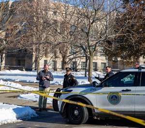 Police investigate a shooting outside of East High School in in Des Moines, Iowa, on Monday, March 7, 2022.