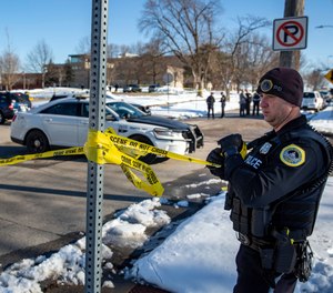 Police investigate a shooting outside of East High School in in Des Moines, Iowa, on Monday, March 7, 2022.