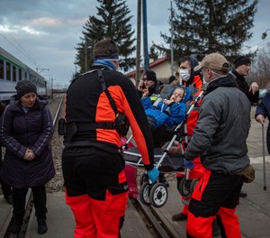 Doctors of the Central Clinical Hospital from Warsaw, Poland carry a Ukrainian child with disabilities to a special train heading to a border crossing on March 10, 2022.