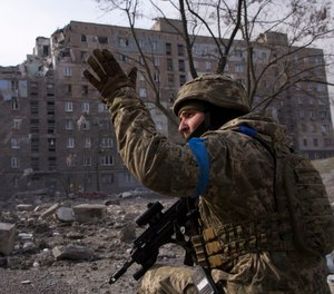 A Ukrainian serviceman guards his position in Mariupol, Ukraine, Saturday, March 12, 2022.