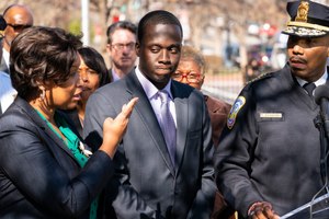 Washington Mayor Muriel Bowser, left, and Washington Metropolitan Police Chief Robert Contee III, right, with Capt. Kevin Kentish.