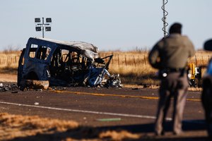 Texas Department of Public Safety Troopers look over the scene of a fatal car wreck early Wednesday in Andrews County, Texas.