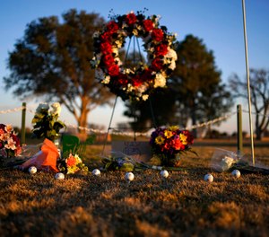 Golf balls adorn a makeshift memorial at the Rockwind Community Links on Wednesday in Hobbs, New Mexico. The memorial was for University of the Southwest student golfers and their coach who died in a crash in Texas.