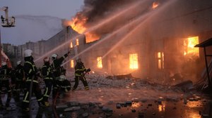 Ukrainian firefighters extinguish a blaze at a warehouse after a bombing in Kyiv, Ukraine, Thursday, March 17, 2022.