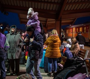 People who fled the war in Ukraine wait at the train station in Przemysl, southeastern Poland, Thursday, March 17, 2022.