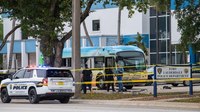 Bus driver pulls up to police headquarters as gunman kills 2 passengers
