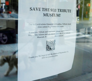 A plea for financial support is posted in the window of the 9/11 Tribute Museum, in New York, Monday, March 21, 2022.