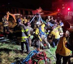 In this image provided by the Contra Costa County Fire Protection District, emergency personnel work on rescuing a man from an underground storm water pipe in Antioch, Calif., Sunday, March 20, 2022.