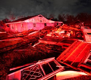 Destroyed homes, illuminated by fire engine lights, are seen after a tornado struck the area in Arabi, La., Tuesday, March 22, 2022.