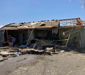 A house that was moved off its foundation during the tornado Tuesday night sits in the street about 30 feet away in Arabi, La., on Wednesday, March 23, 2022.