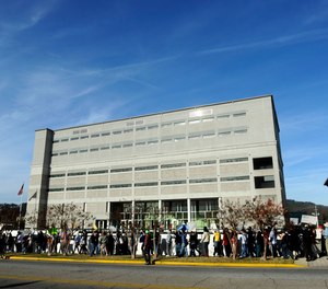 Protesters march in front of the Etowah County Detention Center in Gadsden, Ala., Saturday, Dec. 3, 2011.