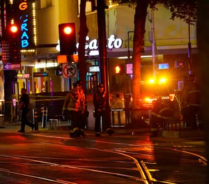 Emergency workers walk in downtown Sacramento, Calif., after an apparent mass shooting Sunday, April 3, 2022.