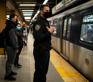 NYPD officers patrol subway platforms after a shooting attack occurred the previous day on Wednesday, April 13, 2022, in New York.