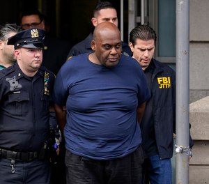 New York City Police and law enforcement officials lead subway shooting suspect Frank R. James, 62, center, away from a police station, in New York, Wednesday, April 13, 2022.