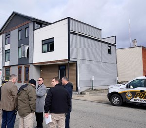 Pittsburgh Police crime scene investigators gather outside the short-term rental property, rear, where a shooting took place at a house party early Sunday morning, April 17, 2022.