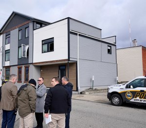 Pittsburgh Police crime scene investigators gather outside the short-term rental property, rear, where a shooting took place at a house party early Sunday morning, April 17, 2022.