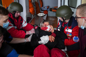 EMS providers move a civilian wounded in shelling onto a stretcher at a maternity hospital converted into a medical ward in Mariupol, Ukraine on March 2.