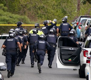 Police respond near the scene of a shooting Friday, April 22, 2022, in northwest Washington. At least four people were shot when a gunman unleashed a flurry of bullets in the nation’s capital.